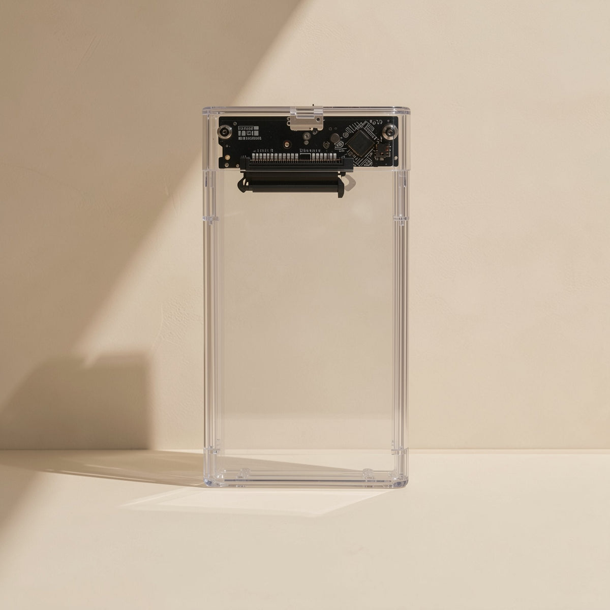 Diskden 2.5-Inch Hard Disk Enclosure, clear case standing upright, circuit board and SATA connector at top