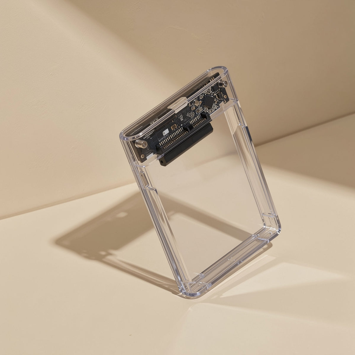 Diskden – Clear enclosure tilted at an angle on a cream surface, internal board and connector visible