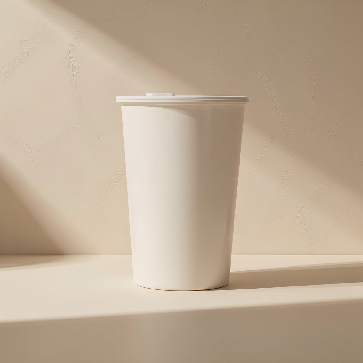 Diskden 2.5-Inch Hard Disk Enclosure – white lidded cup on a cream surface in soft window light, no enclosure visible