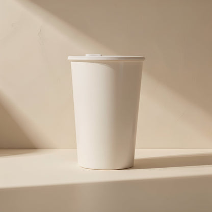 Diskden 2.5-Inch Hard Disk Enclosure – white lidded cup on a cream surface in soft window light, no enclosure visible