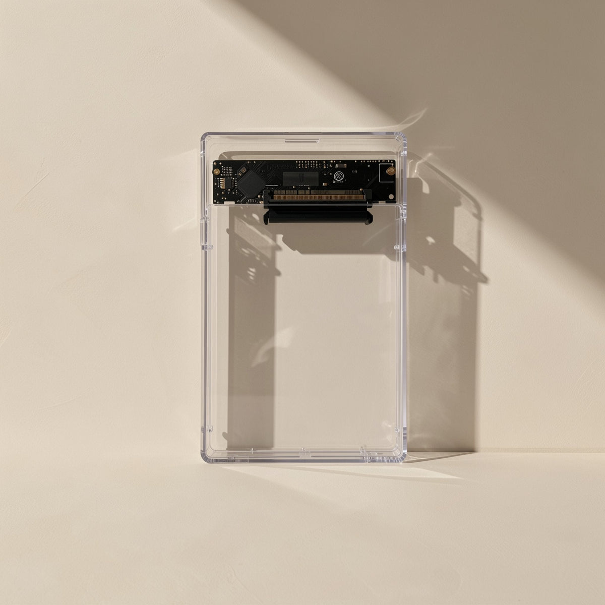 Diskden – Clear enclosure standing upright, close view of the black circuit board and connector at the top edge