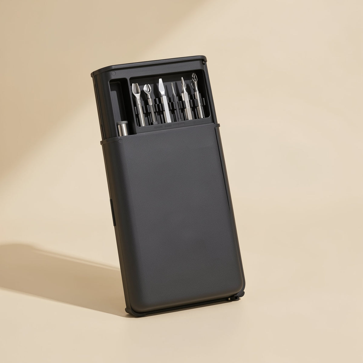 Phonebit Precision Screwdriver Set in a slim black case standing upright, with bits visible in the top tray