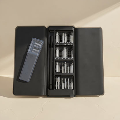 Phonebit – Open black case with a clear bit holder beside the driver handle and four rows of bits on a cream background