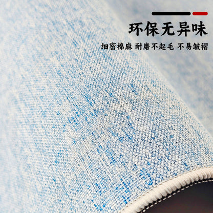 Loomfield Cotton Linen Rubber Desk Pad – close-up of blue woven cotton linen texture on a desk pad with a white stitched edge