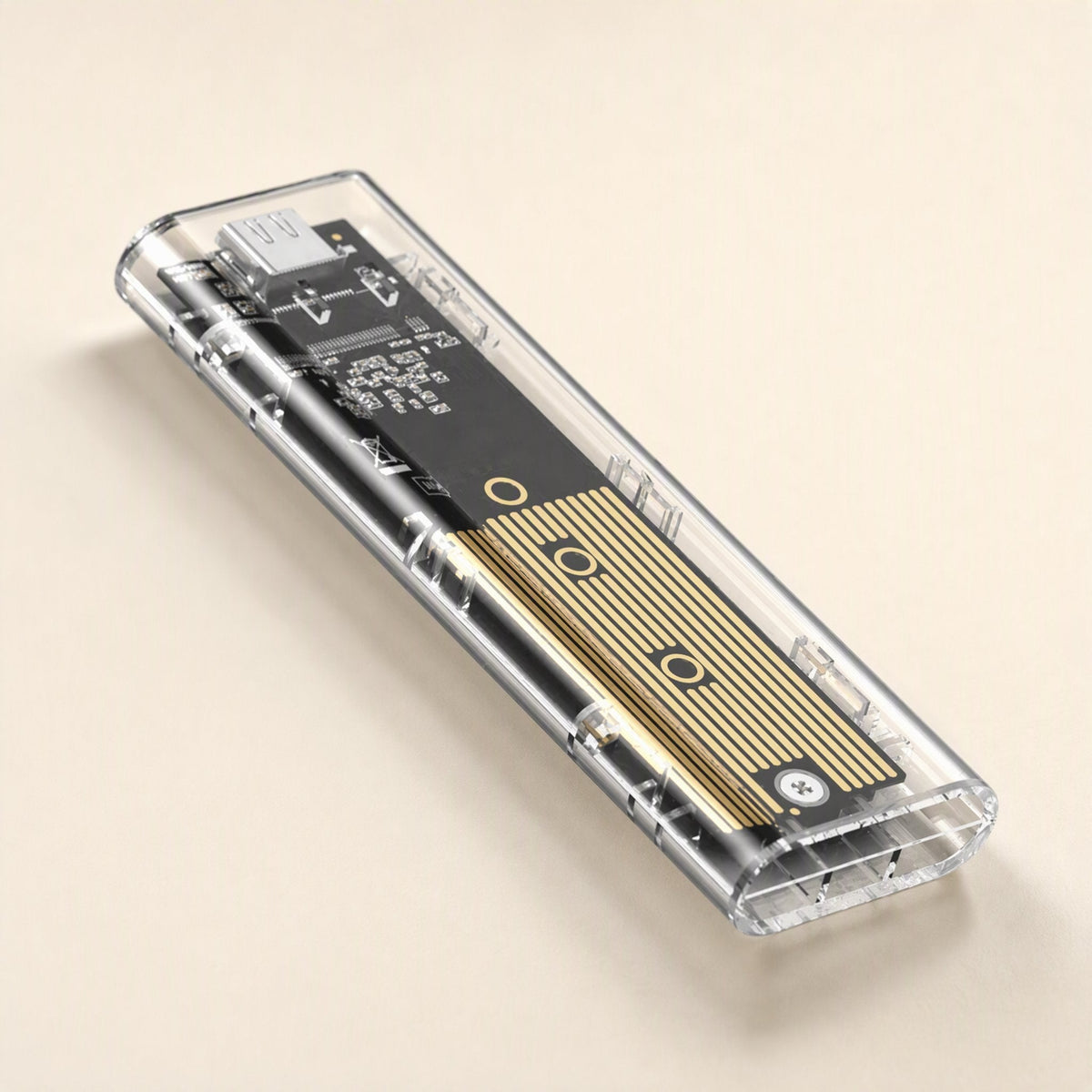 Driveclear – Angled close-up of the clear enclosure showing the gold heatsink strip, screw and USB-C port at the end