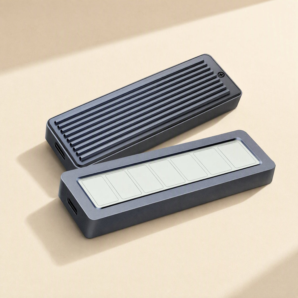 Chillscope – Two gray aluminum enclosures lying flat, one ribbed top with screw, one with blank segmented screen panel