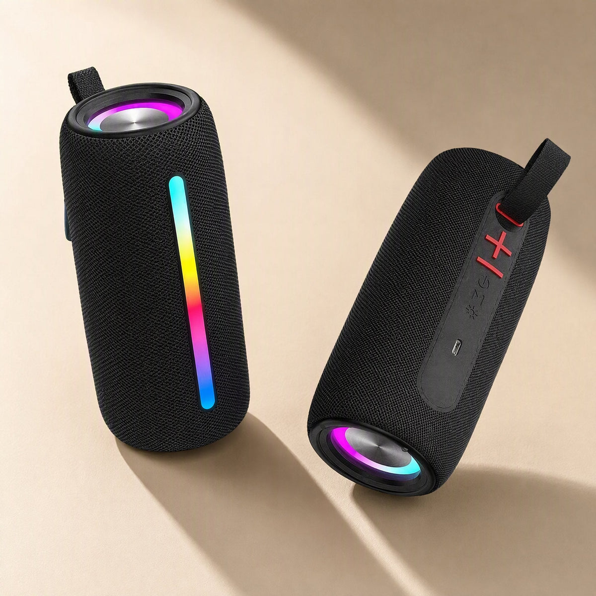 Twinbeat RGB Bluetooth Speaker pair in black, one upright with a glowing rainbow light strip, one lying on its side