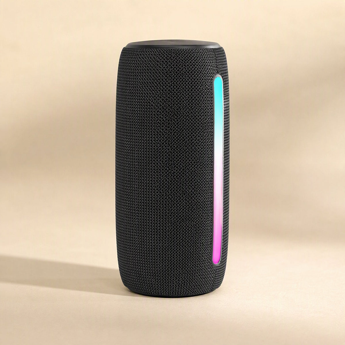 Twinbeat – Black fabric speaker seen from the front with a cyan and pink glowing light strip down one side