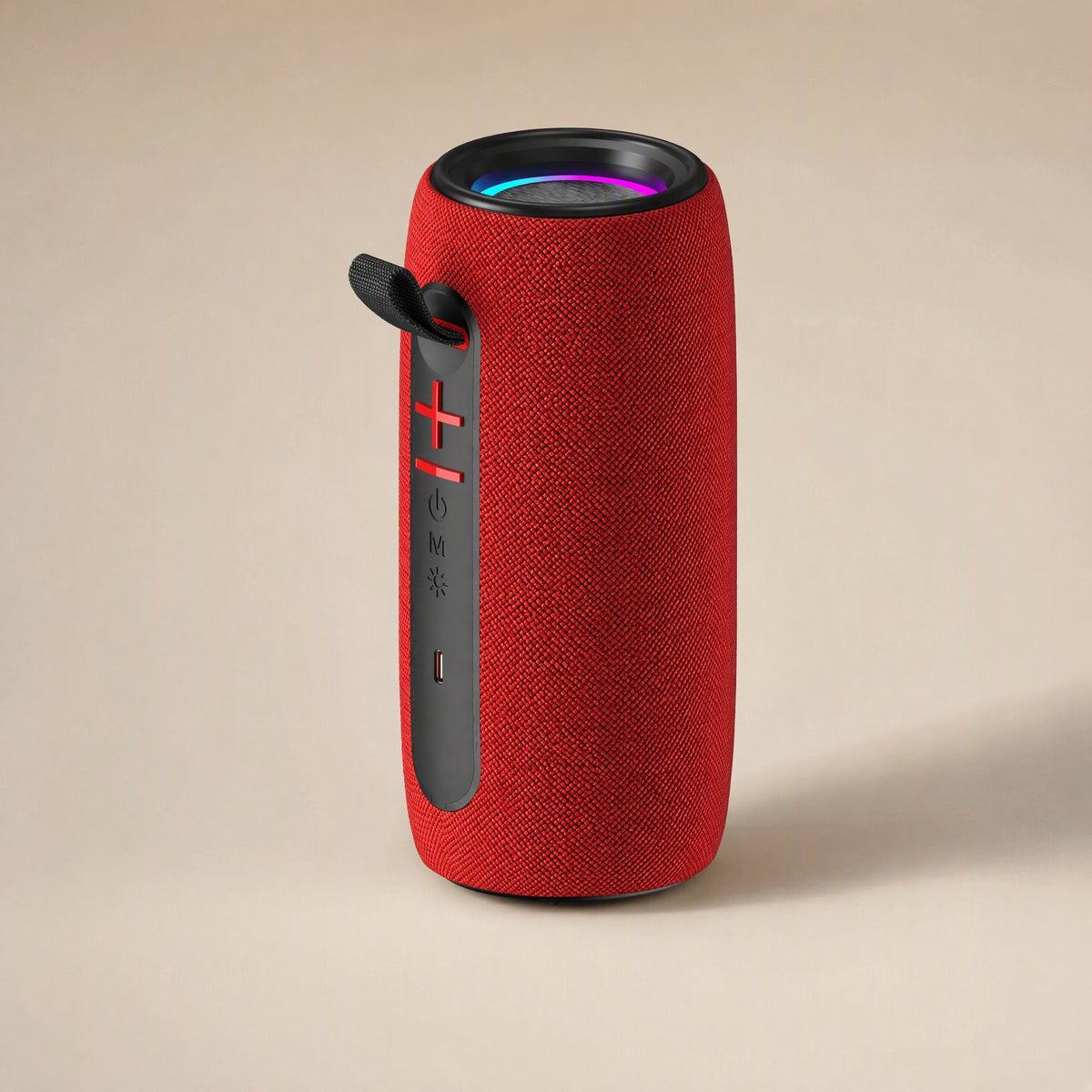 Twinbeat – Red fabric speaker with black side panel showing volume, power, mode and light buttons and a rainbow-lit top ring