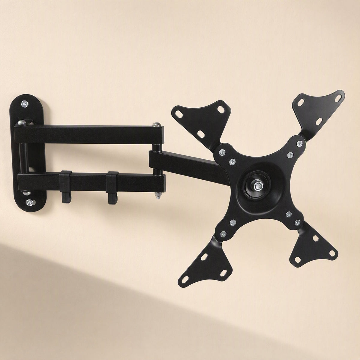 Reachmount – Wall mount with the VESA plate rotated to a diamond angle, showing four mounting arms and screw holes