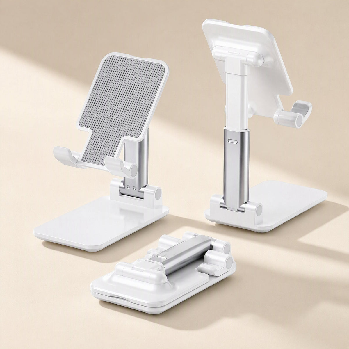 Deskfold foldable phone and tablet stand in white shown open, folded flat, and from the back on beige