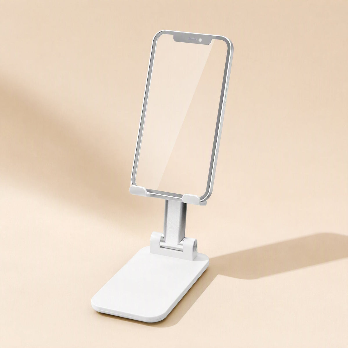 Deskfold – White desktop stand holding a smartphone upright, shown at an angle with a soft shadow on a cream backdrop