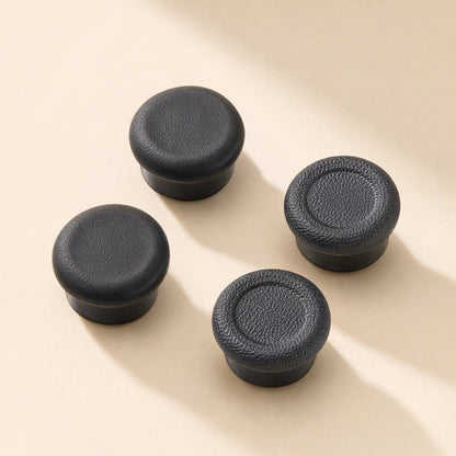 Thumbtread – Four black joystick caps with short stems, two with flat tops and two with raised rim and recessed center