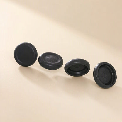 Thumbtread – Four black round caps arranged in a row, shown from different angles including the underside