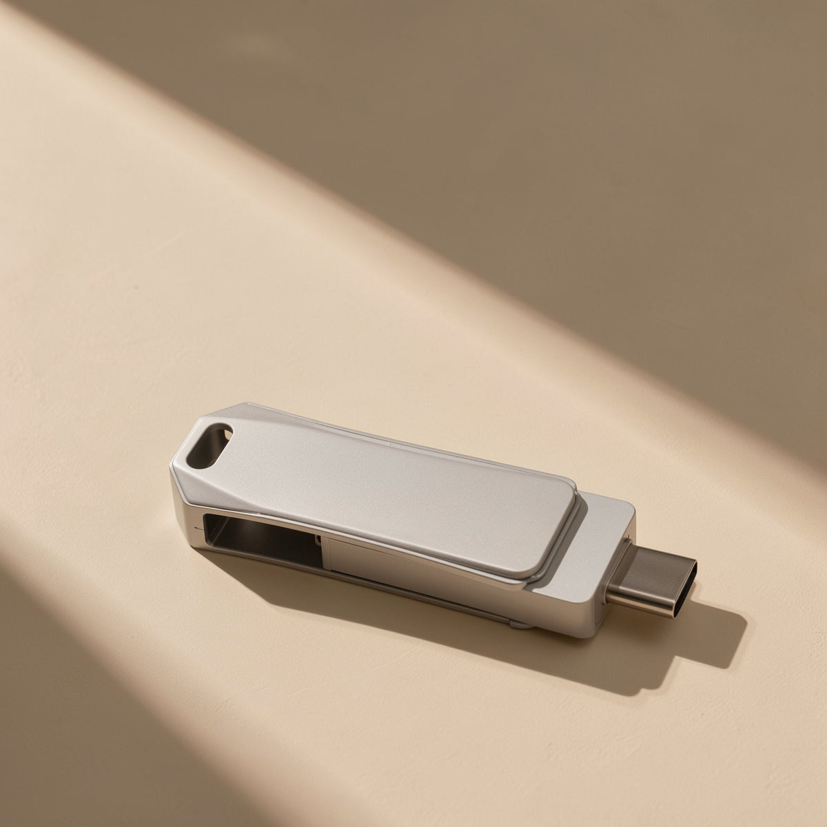 Typeflash – Silver metal swivel drive with its USB-C connector extended, shown from the side with a keyring hole