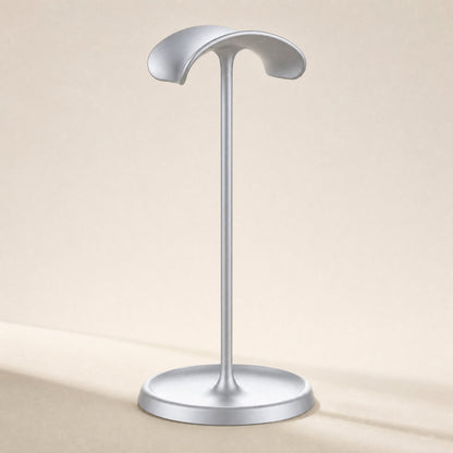 Hookrest – Front view of a single silver stand with a curved headband rest and a round dish base on a cream background
