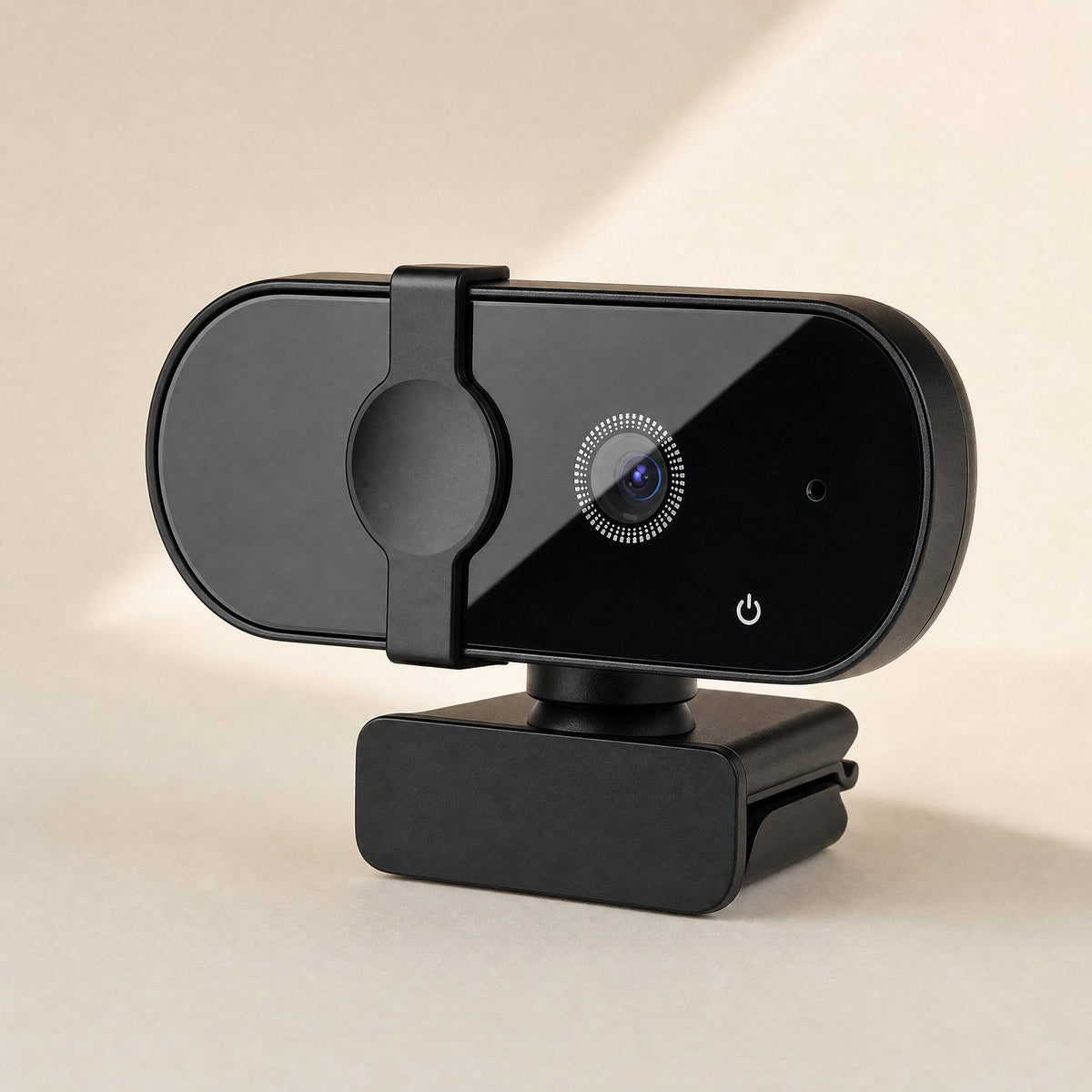 Soundglance – Webcam angled three-quarter view showing glossy black face, lens ring, power icon, and clip-style stand base