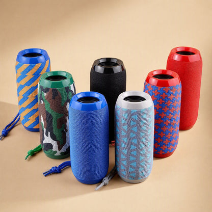 Pocketbeat Portable Bluetooth Speaker in seven fabric colours and patterns, grouped on a tan backdrop