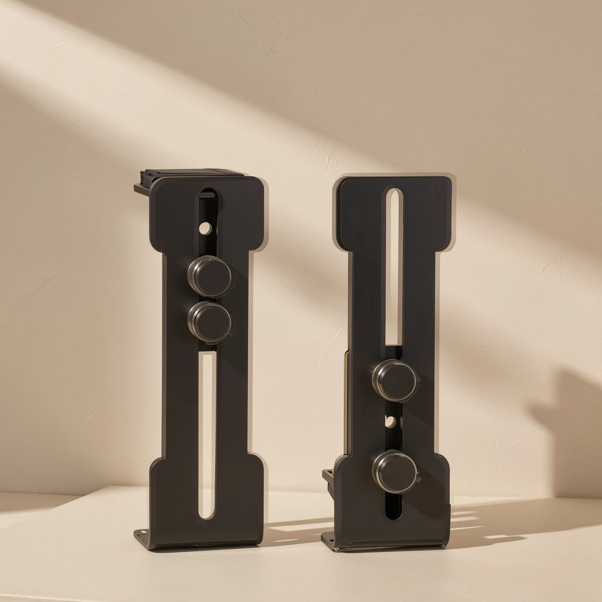 Anglehold L-Shaped Graphics Card Support Bracket in black, front and rear views with adjustable slots and knobs