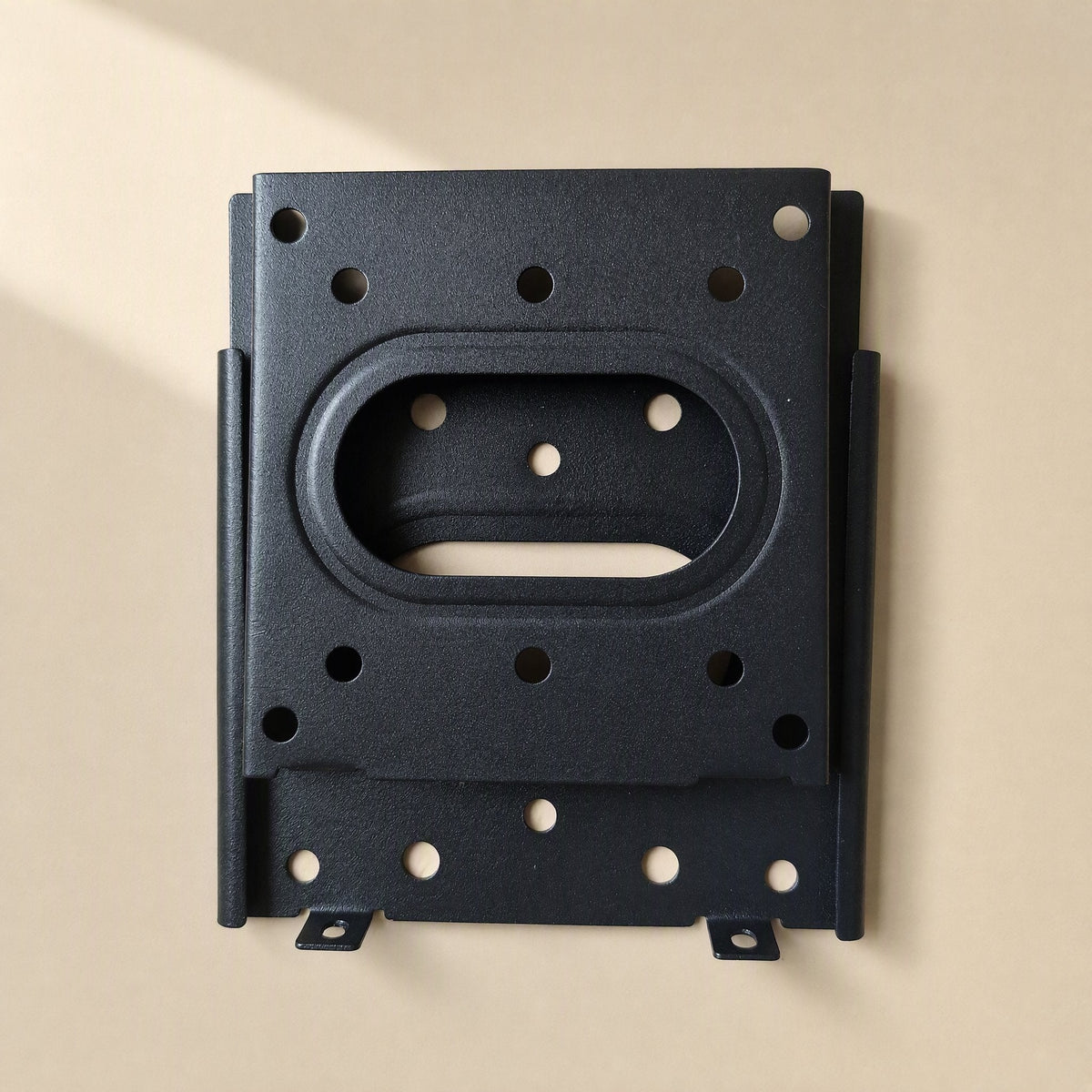 Walllock – Front view of black wall plate with oval cutout, mounting holes and two lock tabs at the bottom