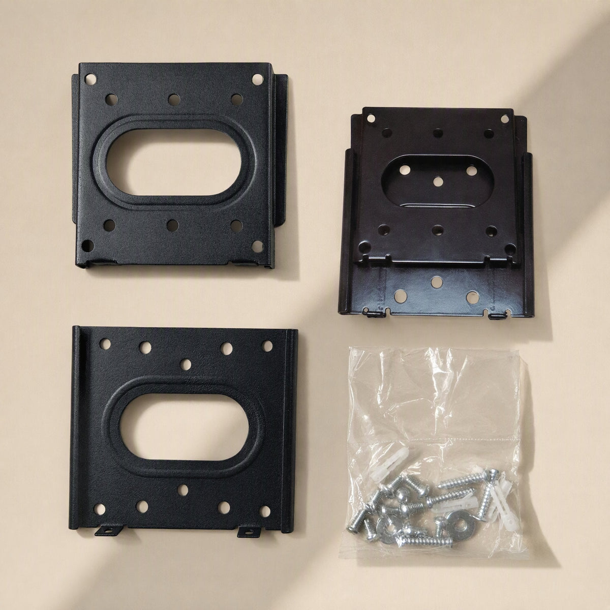 Walllock – Both bracket plates laid out beside a clear bag of screws and wall anchors on a beige surface