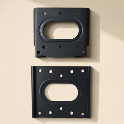 Walllock – Two black bracket plates shown from above, one with raised edges and one flat, each with an oval cutout