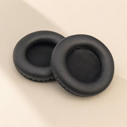 Earcush – Two black round earpads shown from a different angle, revealing the soft inner cushion opening