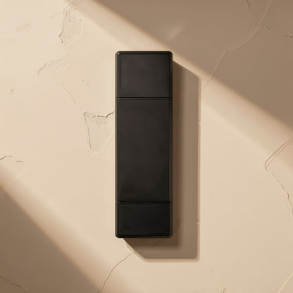 Readlink – Top-down view of the black reader's plastic body, with a hard diagonal shadow across the beige surface