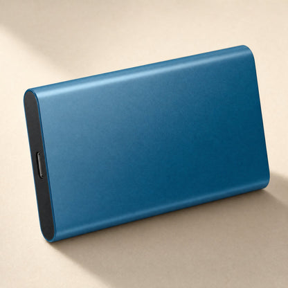 Datapocket – Blue metal portable SSD standing on its long edge, USB-C port visible on the end, on a beige surface