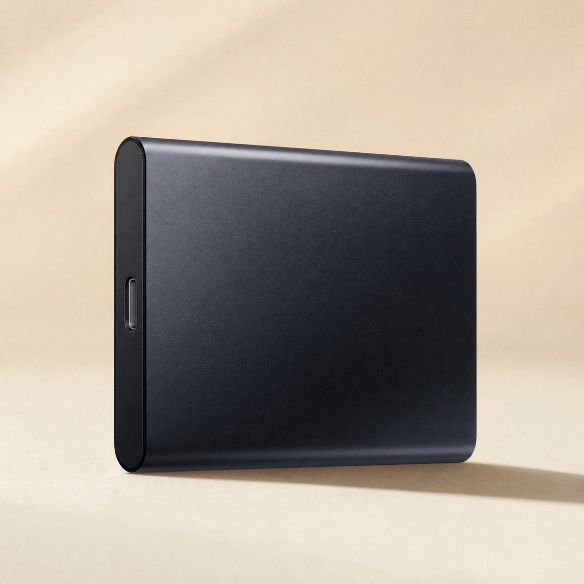 Datapocket – Navy portable SSD standing upright with USB-C port on the lower end, soft light on a cream backdrop