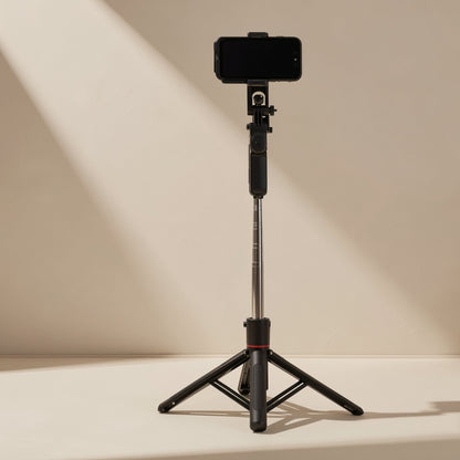 Snapframe – Selfie stick extended on its folded-out black tripod legs with a phone mounted on top, red ring at the base