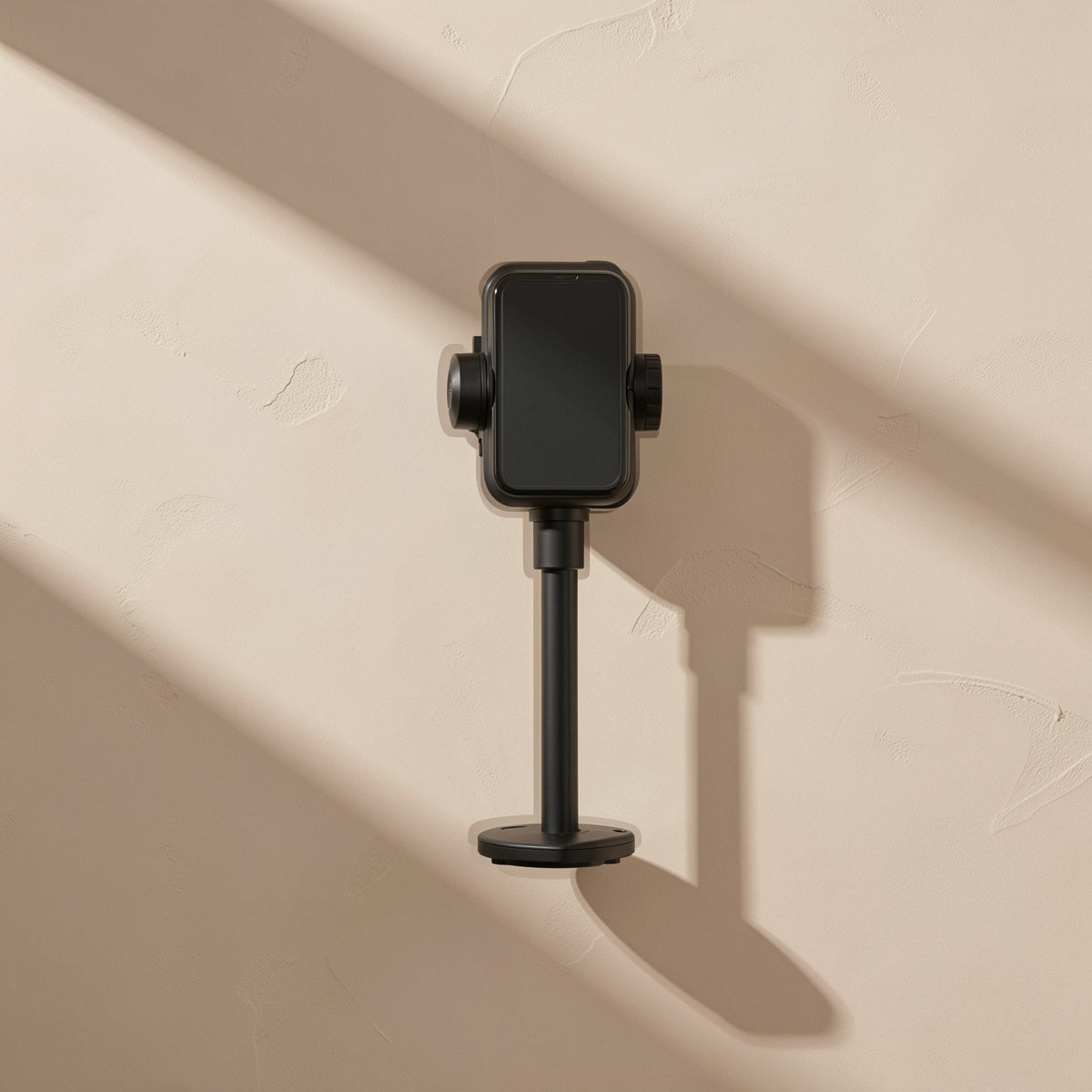 Tiltperch – Black phone bracket viewed from the front, holding a phone on a slim pole with a round base
