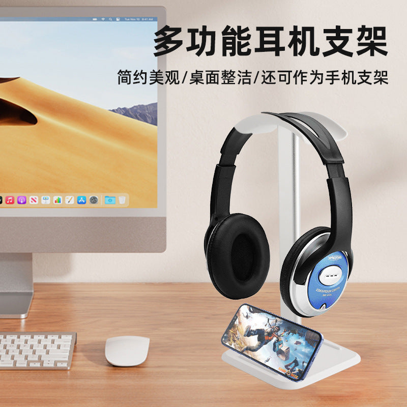 Perchvale – White stand with headphones on top and a phone resting in the base slot, next to an iMac and mouse