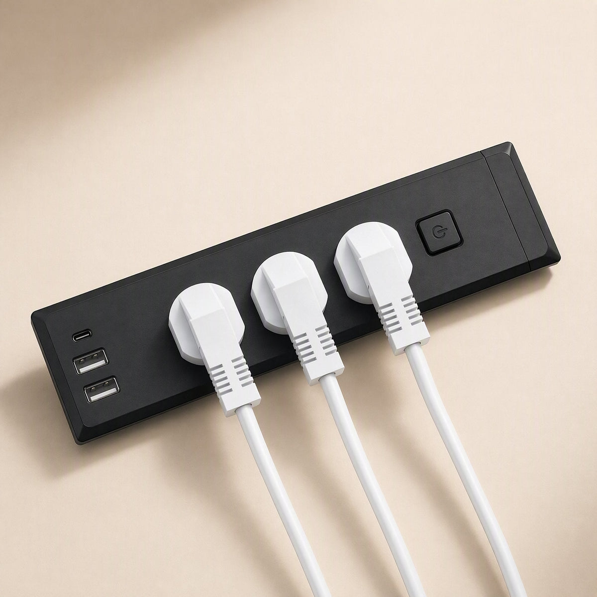 Desknest – Black strip with three white plugs inserted, plus USB-C and two USB-A ports and a round power button