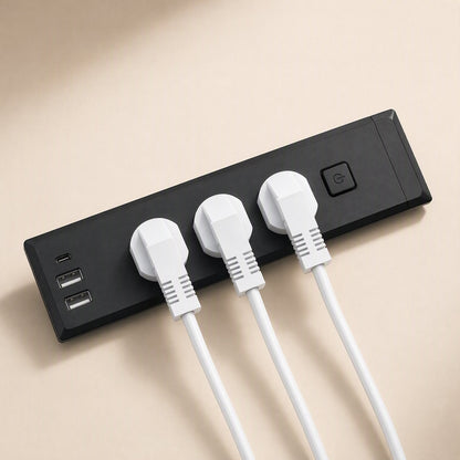 Desknest – Black strip with three white plugs inserted, plus USB-C and two USB-A ports and a round power button