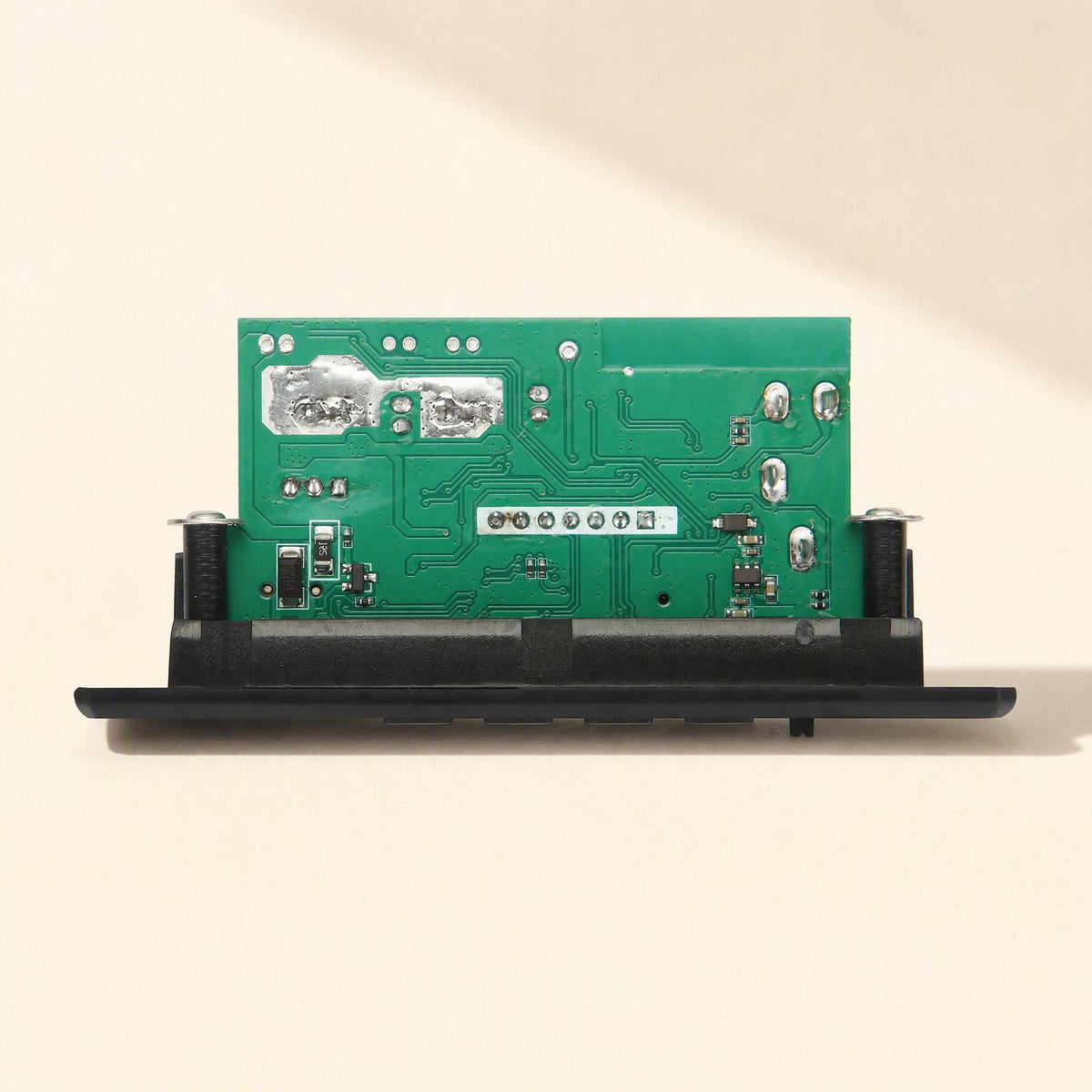 Ampcraft – Rear of the board showing green circuit board, solder pads and a row of connection pins