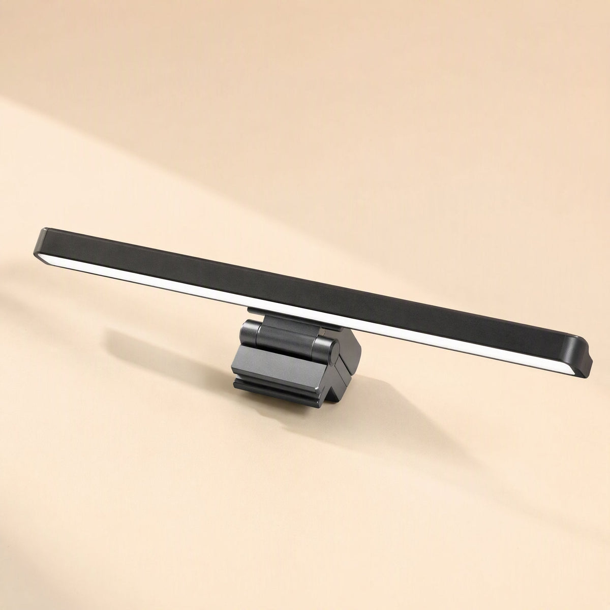 Usbglow – Black light bar with a glowing white strip, hinged clip underneath, on a soft beige background