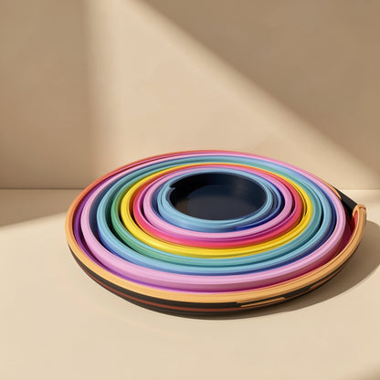 Neonflex – Neon strip wound in tight concentric rings in pink, yellow, green and blue around a dark center