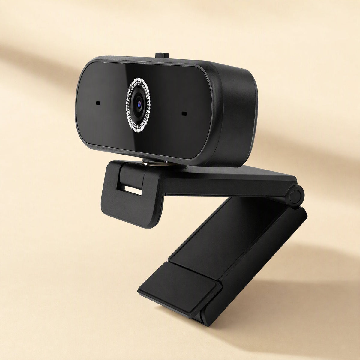 Talkframe – Webcam seen from the left with its hinged clip arm extended, lens and two microphone holes visible