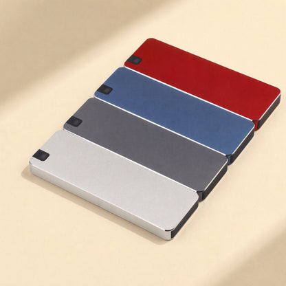 Steeldrive – Four metal SSDs in red, blue, gray and silver lined up in a diagonal row on a cream background
