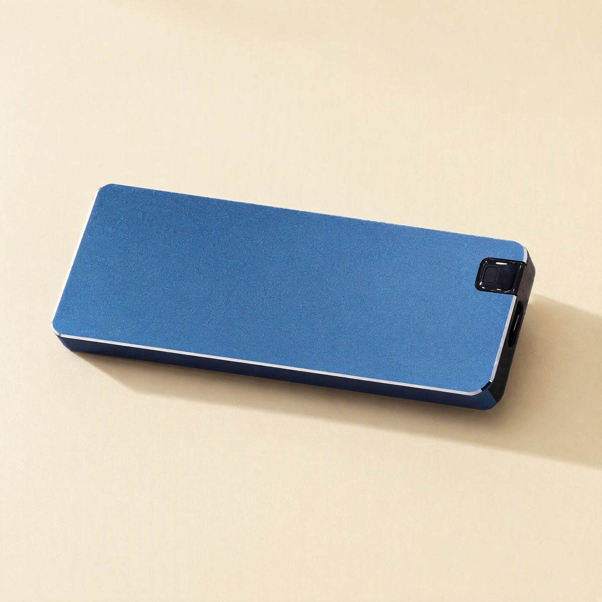 Steeldrive – Blue metal external drive lying flat, with its black end cap and brushed matte surface