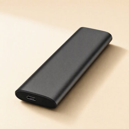 Steeldisk Metal Shell Solid State Drive in black, angled view showing the USB-C port on a cream background
