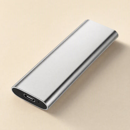 Steeldisk – Silver aluminum SSD at an angle, USB-C port and small indicator hole visible at the end