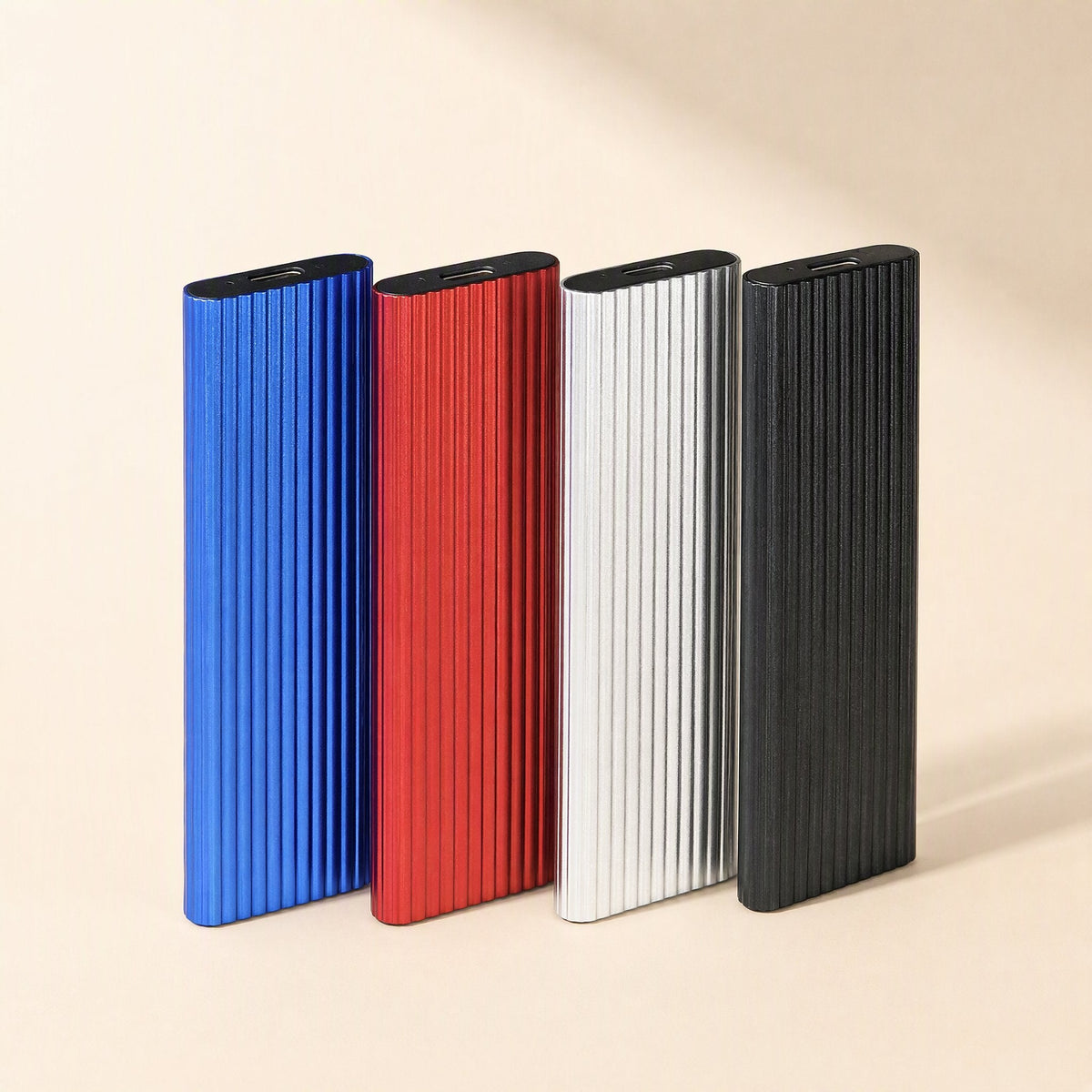 Driveswift Portable Solid State Drive in blue, red, silver and black standing upright, ribbed metal shells