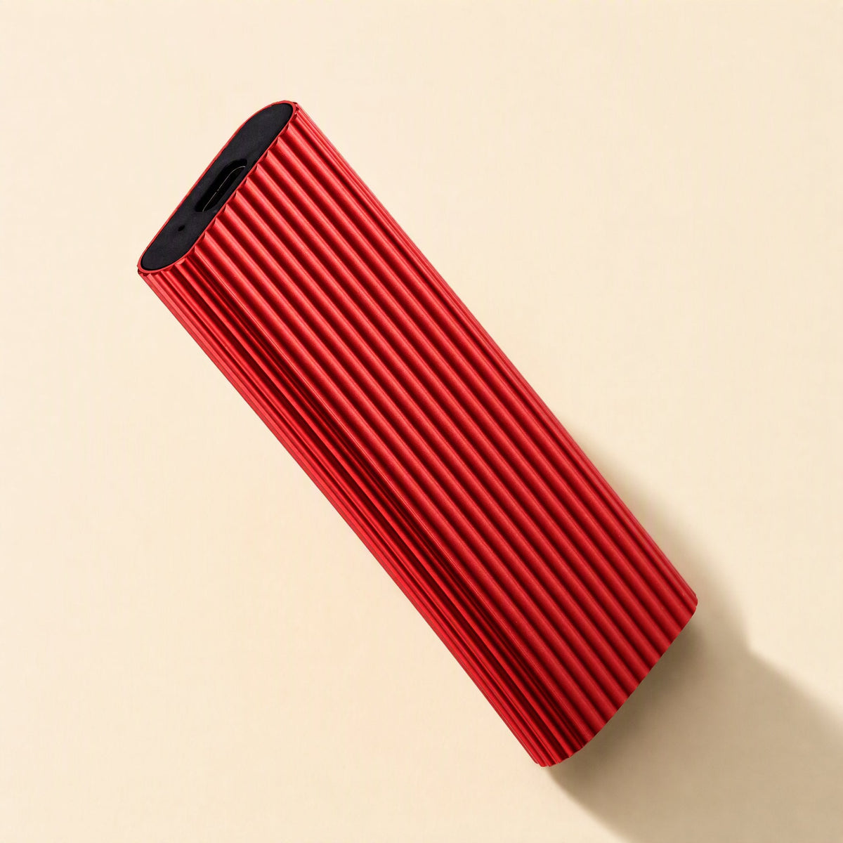 Driveswift Portable Solid State Drive – red ribbed metal drive angled to show the USB-C port on its black end cap