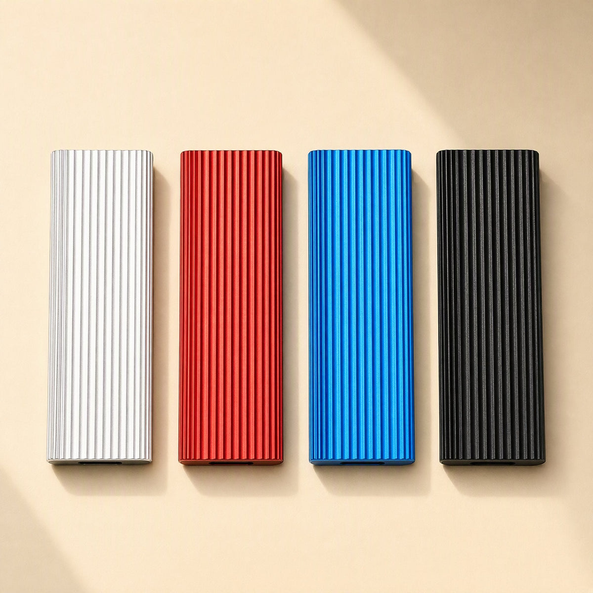 Driveswift – Top-down row of silver, red, blue and black ribbed aluminum drives on a beige background