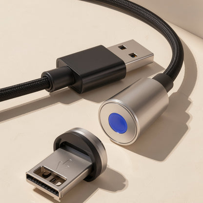 Magtrio – Silver magnetic connector head with blue LED beside its detached Lightning-style tip, USB-A plug behind