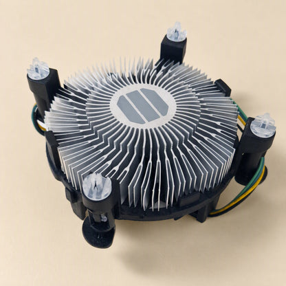 Chipbreeze – Underside angle of the circular aluminum fin heatsink with grey thermal pad and four mounting pins