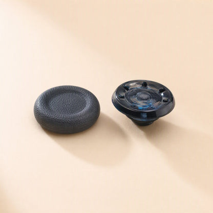 Stickgrip – Close-up of a textured black grip cap beside a clear blue cap base with a dotted underside