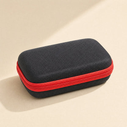 Padpouch – Closed black hard EVA case with red zipper, seen from a three-quarter angle on a cream background
